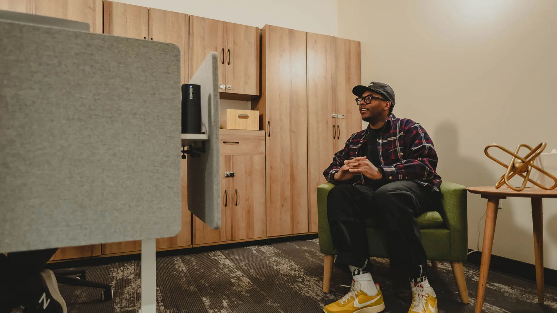 A man sitting in an on-site medical examination room