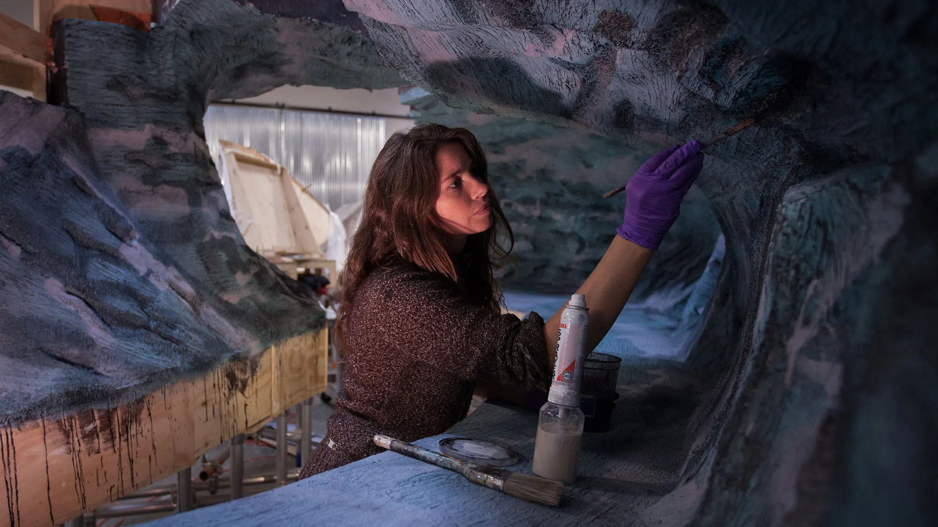 A woman painting a set