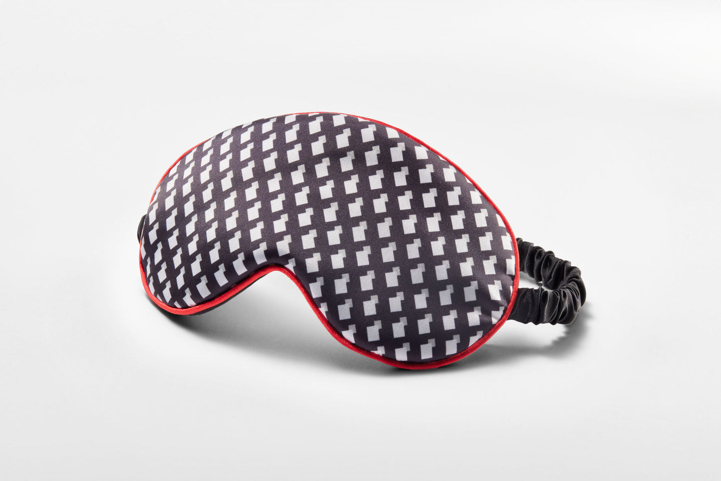 Sleep mask featuring a pattern inspired by Other Mother's black and white dress