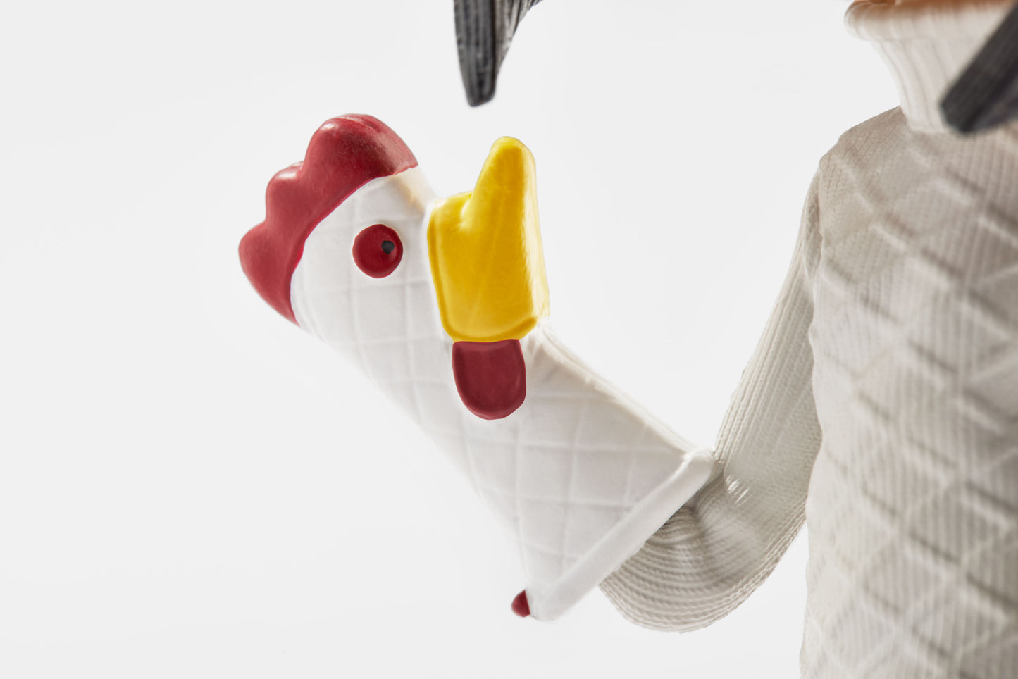 Close-up of the Other Mother Bobblehead's chicken oven mitt