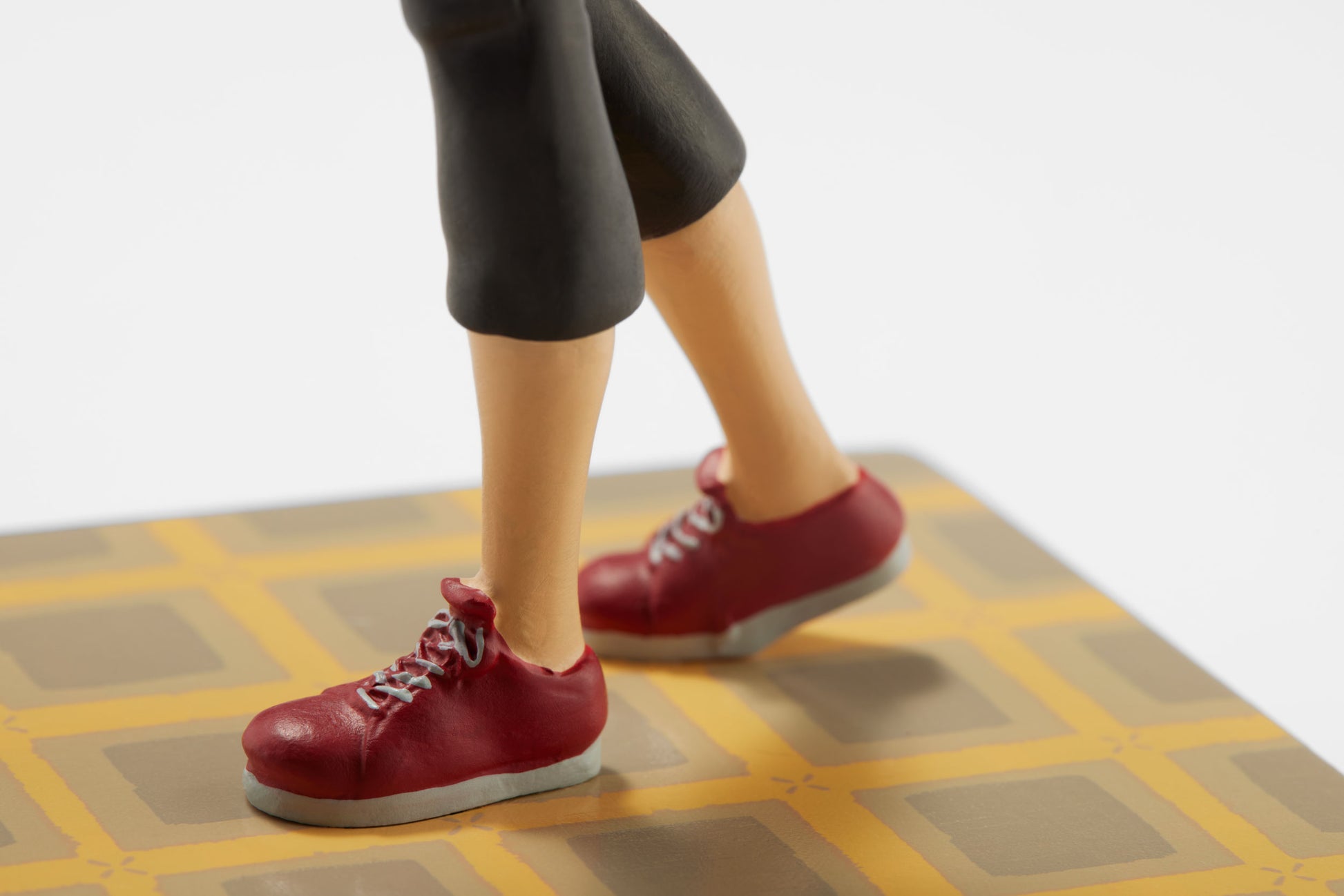 Close-up of the Other Mother Bobblehead's red sneakers