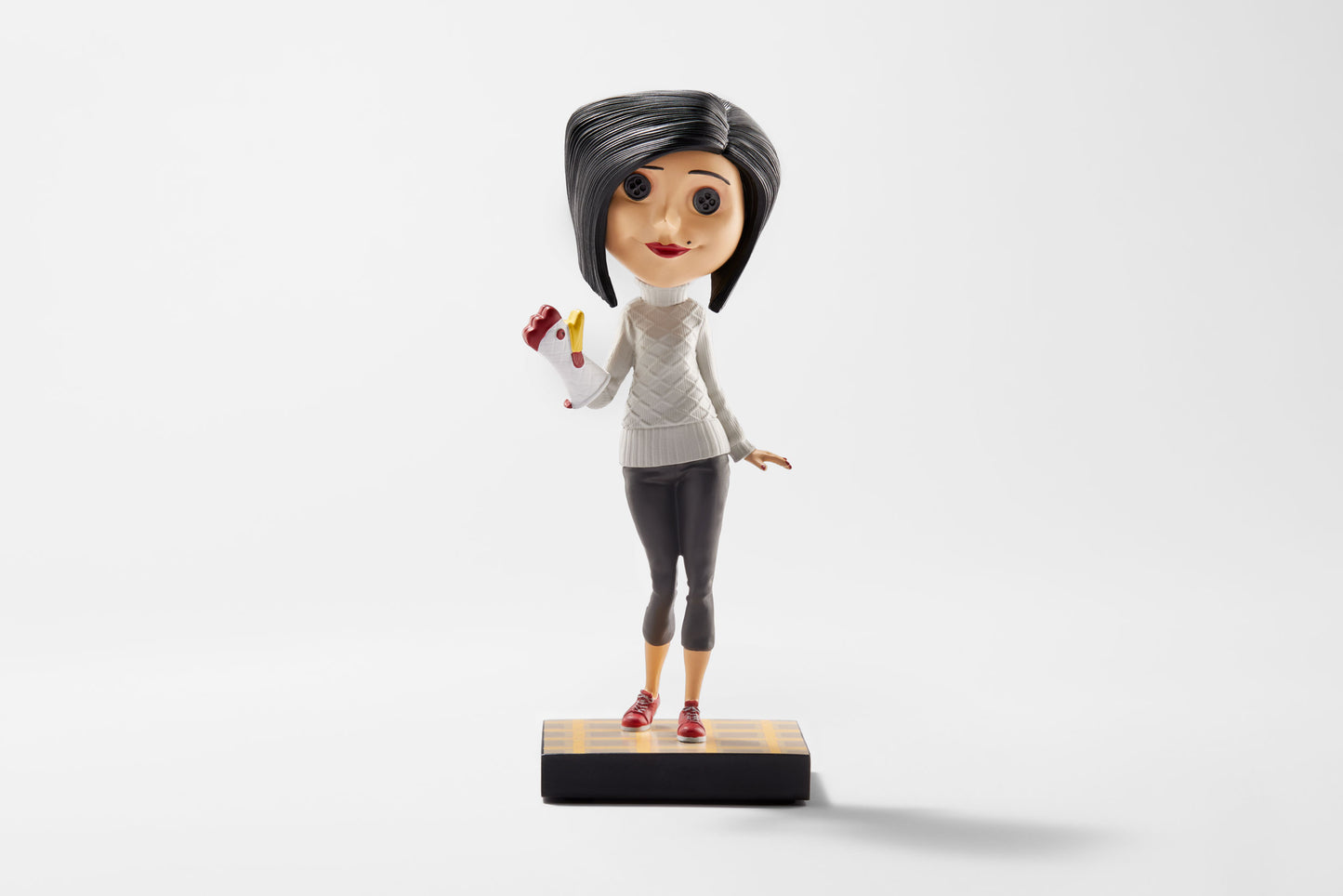 Other Mother Bobblehead wearing a chicken oven mitt and standing on a kitchen tile-style base