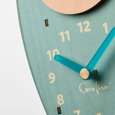 Coraline squid pendulum clock close-up featuring the hands of the clock