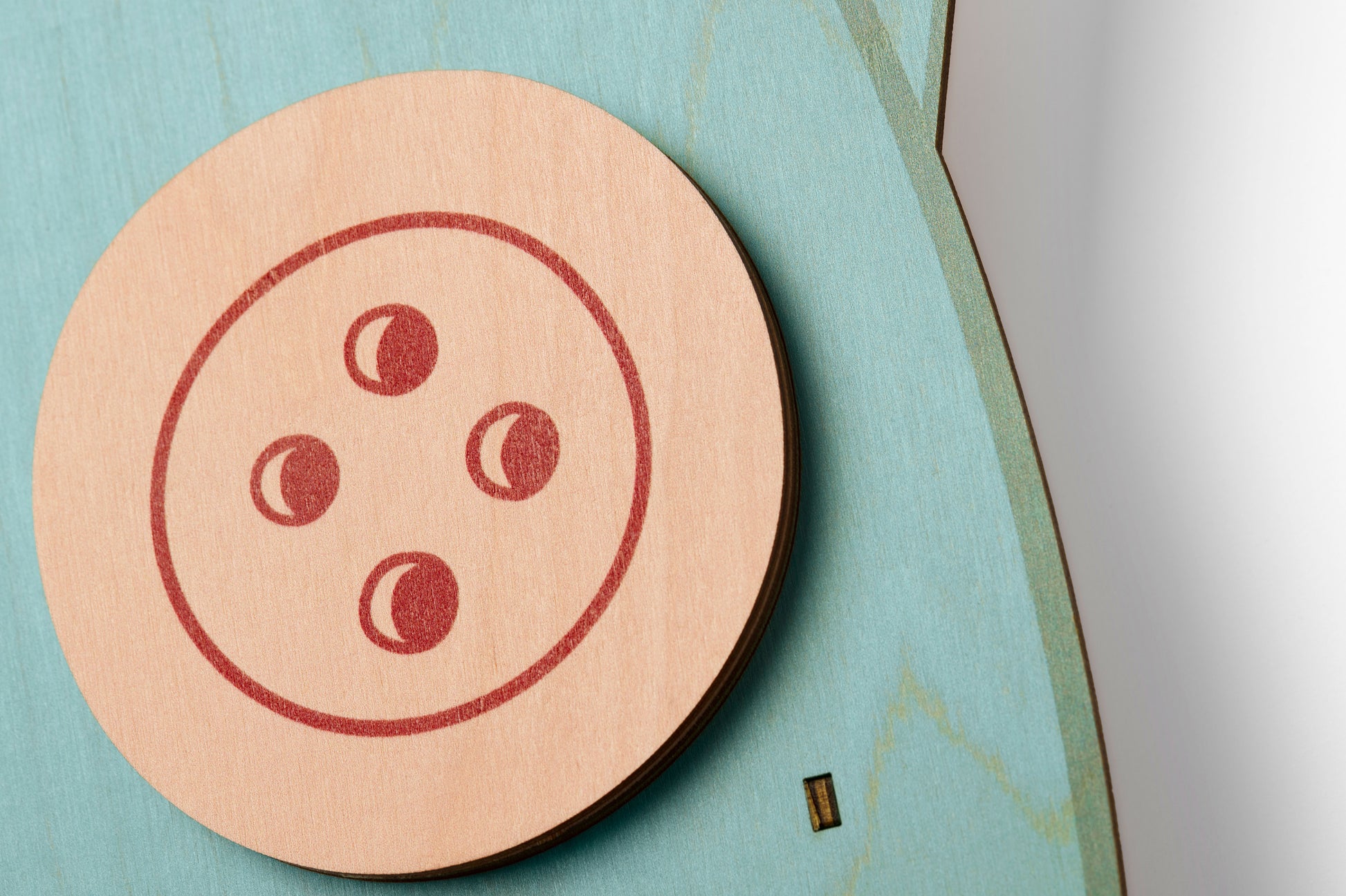 Coraline squid pendulum clock close-up featuring the button eye