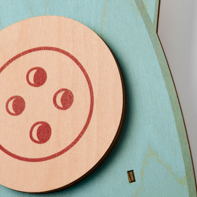 Coraline squid pendulum clock close-up featuring the button eye