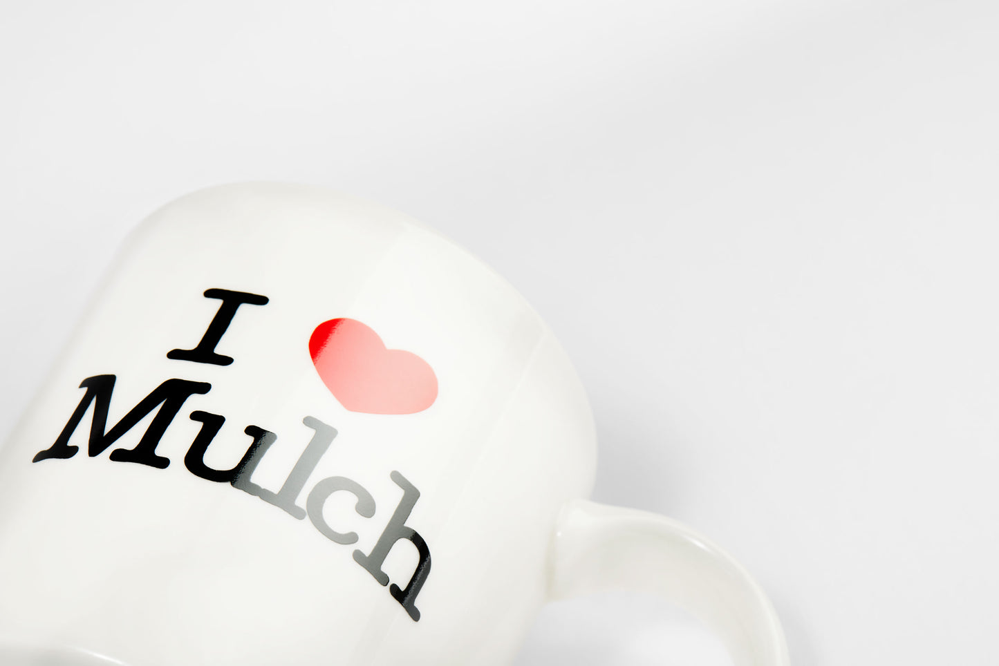 Angled view of the 'I Heart Mulch' Mug tilted away from the camera