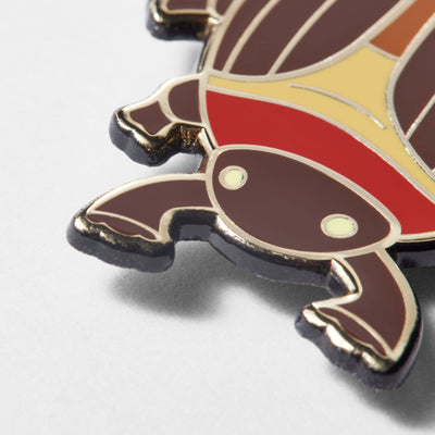 Close-up of cocoa beetle enamel pin, showing the details of the beetle's head