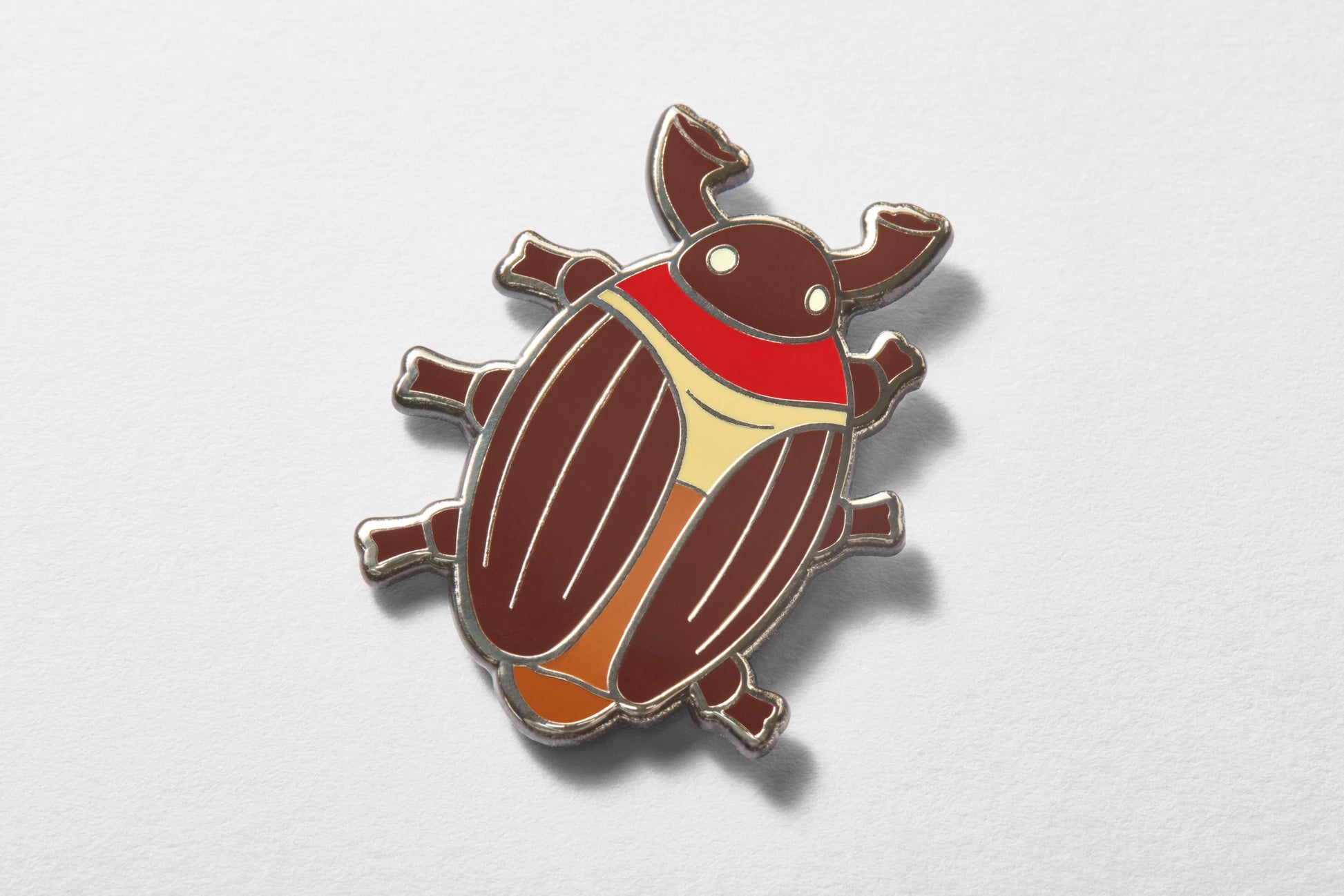 Close-up of cocoa beetle enamel pin