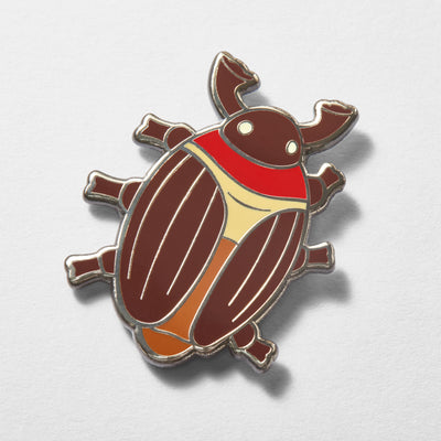 Close-up of cocoa beetle enamel pin